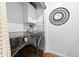 Modern laundry room features a front load washer/dryer, storage cabinets, and stylish décor at 11771 Elk Head Range Rd, Littleton, CO 80127