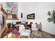 Bright and airy living room featuring high ceilings, hardwood floors, and a cozy leather sectional at 11771 Elk Head Range Rd, Littleton, CO 80127
