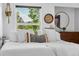 Bright main bedroom with a large window, white linens, and decorative accents at 11771 Elk Head Range Rd, Littleton, CO 80127