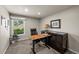 Comfortable office space featuring natural light, a modern desk, and dark wood furnishings at 11771 Elk Head Range Rd, Littleton, CO 80127