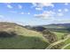 Scenic view of green valley with rolling hills under a blue sky, highlighting the area's beauty at 11771 Elk Head Range Rd, Littleton, CO 80127