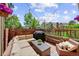 Relaxing outdoor patio area with comfortable seating, a grill, and string lights at 11771 Elk Head Range Rd, Littleton, CO 80127