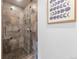 Tiled walk-in shower featuring unique pebble flooring and modern fixtures at 11771 Elk Head Range Rd, Littleton, CO 80127