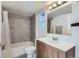 Bathroom features a shower and tub combo with tile surround and single vanity at 12338 W Dorado Pl # 107, Littleton, CO 80127