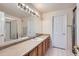 Well-lit bathroom boasts spacious vanity with sleek hardware and tile flooring at 12338 W Dorado Pl # 107, Littleton, CO 80127