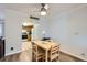 Bright dining area features hardwood floors and a modern ceiling fan at 12338 W Dorado Pl # 107, Littleton, CO 80127