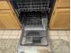 Interior view of the dishwasher, revealing its racks, spray arms, and utensil holder for sparkling results at 12338 W Dorado Pl # 107, Littleton, CO 80127