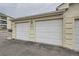 Attached two car garage features painted doors and close proximity to the building at 12338 W Dorado Pl # 107, Littleton, CO 80127