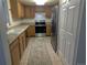 Efficient U-shaped kitchen featuring modern appliances, wood cabinets, and a seamless flow for cooking at 12338 W Dorado Pl # 107, Littleton, CO 80127