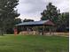 Open-air wooden pavilion with picnic tables and a blue metal roof, perfect for outdoor gatherings at 12338 W Dorado Pl # 107, Littleton, CO 80127
