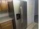 Stainless steel side-by-side refrigerator with a built-in water dispenser and freezer at 12338 W Dorado Pl # 107, Littleton, CO 80127