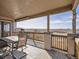 Relaxing outdoor porch with a table and chairs, offering a view of the countryside at 14855 Almstead St, Hudson, CO 80642