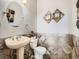Chic powder room with elegant fixtures, decorative tile, and a stylish vanity, perfect for guests and everyday convenience at 14855 Almstead St, Hudson, CO 80642