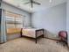 Cozy bedroom with carpeted floors, a ceiling fan, window blinds, and a comfortable bed at 14855 Almstead St, Hudson, CO 80642