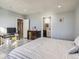 Bright bedroom featuring tile floors, white trim, neutral walls, and a private bathroom at 14855 Almstead St, Hudson, CO 80642