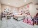 Adorable bedroom with playful decor, tile flooring, and a cozy tent at 14855 Almstead St, Hudson, CO 80642