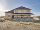 Charming two-story home with a welcoming covered porch and ample natural light, perfect for enjoying peaceful outdoor living at 14855 Almstead St, Hudson, CO 80642