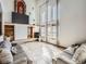 Bright living room with large windows, tile floors, and fireplace, offering a cozy space for relaxation and entertainment at 14855 Almstead St, Hudson, CO 80642