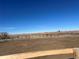 View of paddock, wooden fencing and plains leading to a mountain range in the distance at 14855 Almstead St, Hudson, CO 80642