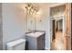 This bathroom features grey cabinets, a white toilet and an octagonal mirror at 336 N Grant St # 412, Denver, CO 80203