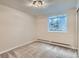 This bedroom features neutral paint, a large window, carpet and baseboard heaters at 336 N Grant St # 412, Denver, CO 80203