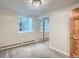 This bedroom features neutral paint, a large window, carpet, mirrored closet doors and a wood door at 336 N Grant St # 412, Denver, CO 80203
