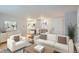 Bright living room featuring modern furnishings, including a white sofa and stylish decor, with a kitchen and dining space visible at 336 N Grant St # 412, Denver, CO 80203