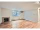 Bright and airy living room featuring hardwood floors, a fireplace, and a large window allowing for ample natural light at 336 N Grant St # 412, Denver, CO 80203