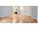 Spacious living room boasting hardwood floors, leading to the entrance door and a view of the kitchen area at 336 N Grant St # 412, Denver, CO 80203