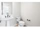 A half bathroom with a pedestal sink and modern fixtures at 6675 Fawn Path Ln, Castle Pines, CO 80108