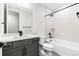 Bathroom with a gray vanity with black hardware, a toilet, and a tub with a shower at 6675 Fawn Path Ln, Castle Pines, CO 80108
