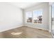Bright bedroom features hardwood floors, two windows, and neutral paint for a modern, airy feel at 6675 Fawn Path Ln, Castle Pines, CO 80108