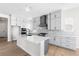 Modern kitchen with white cabinets, a spacious island, stainless steel appliances, and marble backsplash at 6675 Fawn Path Ln, Castle Pines, CO 80108