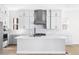 Bright kitchen featuring a large island with a white countertop and ample storage and stainless steel appliances at 6675 Fawn Path Ln, Castle Pines, CO 80108
