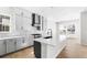 Open-concept kitchen featuring a large island, stainless appliances, and hardwood flooring for a modern living space at 6675 Fawn Path Ln, Castle Pines, CO 80108
