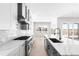 Bright kitchen featuring a large island with white countertops and modern stainless steel appliances at 6675 Fawn Path Ln, Castle Pines, CO 80108