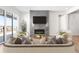 Bright living room featuring a modern fireplace, large sliding glass doors, and stylish decor at 6675 Fawn Path Ln, Castle Pines, CO 80108