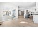 Open-concept floor plan with large sliding doors, a hardwood floor, and a kitchen with an island at 6675 Fawn Path Ln, Castle Pines, CO 80108