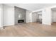 Bright living room featuring a modern fireplace, hardwood floors, and neutral walls at 6675 Fawn Path Ln, Castle Pines, CO 80108
