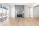 Bright living room featuring a modern fireplace, large sliding glass doors, and hardwood floors at 6675 Fawn Path Ln, Castle Pines, CO 80108