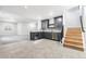 Basement wet bar with gray cabinets, stylish backsplash, stainless steel appliances, and tile flooring at 6675 Fawn Path Ln, Castle Pines, CO 80108