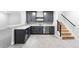 Basement wet bar featuring gray cabinets, quartz counters, stainless steel appliances, and a tiled floor at 6675 Fawn Path Ln, Castle Pines, CO 80108