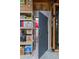 Basement with a gray safe door adjacent to shelves stocked with storage boxes and household items at 4275 S Dawson St, Aurora, CO 80014