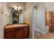 Bathroom featuring tile flooring, a vanity with black countertop, an undermount sink, and a tub/shower combo at 4275 S Dawson St, Aurora, CO 80014
