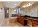 Luxurious bathroom with dual sinks, granite countertops, soaking tub, and tiled shower with a glass door at 4275 S Dawson St, Aurora, CO 80014