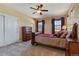 Bedroom with neutral carpet, wooden bedroom set, ceiling fan, and plenty of natural light from windows at 4275 S Dawson St, Aurora, CO 80014