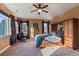 Bright bedroom with neutral carpet and plenty of natural light, featuring a ceiling fan and light fixture at 4275 S Dawson St, Aurora, CO 80014