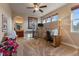 Bright bedroom features neutral decor, a ceiling fan, and a convenient pass-through to the bathroom at 4275 S Dawson St, Aurora, CO 80014