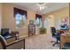 Bedroom boasts comfortable seating, ample natural light from large windows, and neutral carpet at 4275 S Dawson St, Aurora, CO 80014