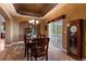 Elegant dining room with a tray ceiling and a large table at 4275 S Dawson St, Aurora, CO 80014
